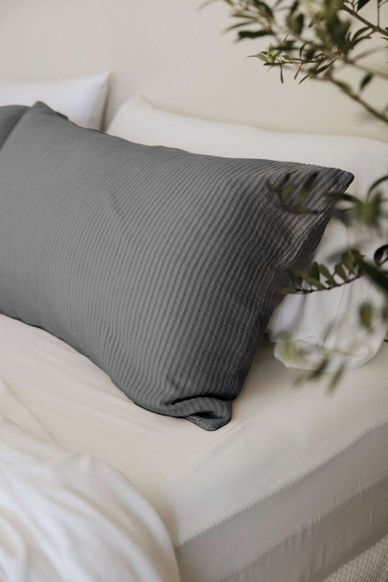 Charcoal coverlet sham on white bed