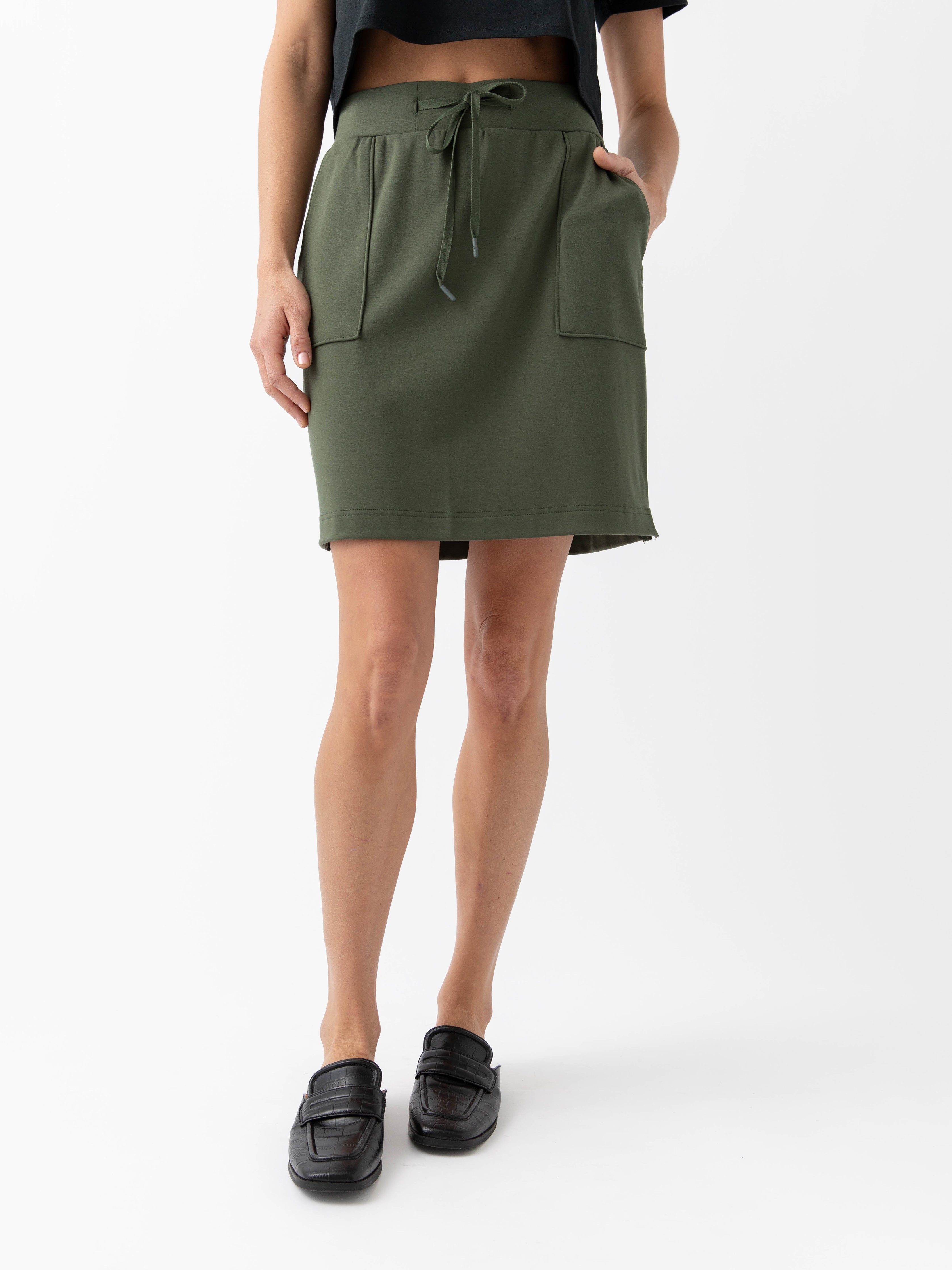 Person wearing a Cozy Earth Brushed Bamboo Patch Pocket Skirt in green on a white background |Color:Olive