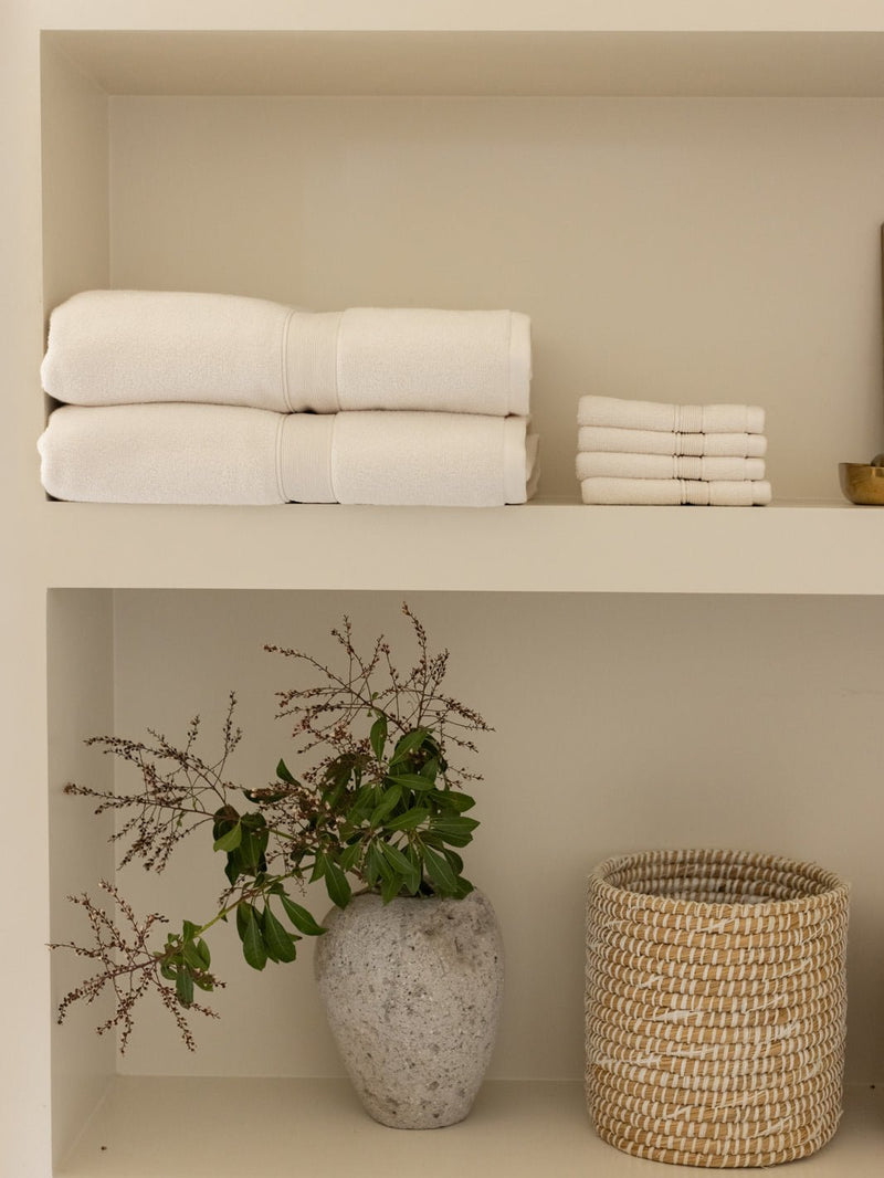 Seashell luxe bath sheets and washcloths on shelf