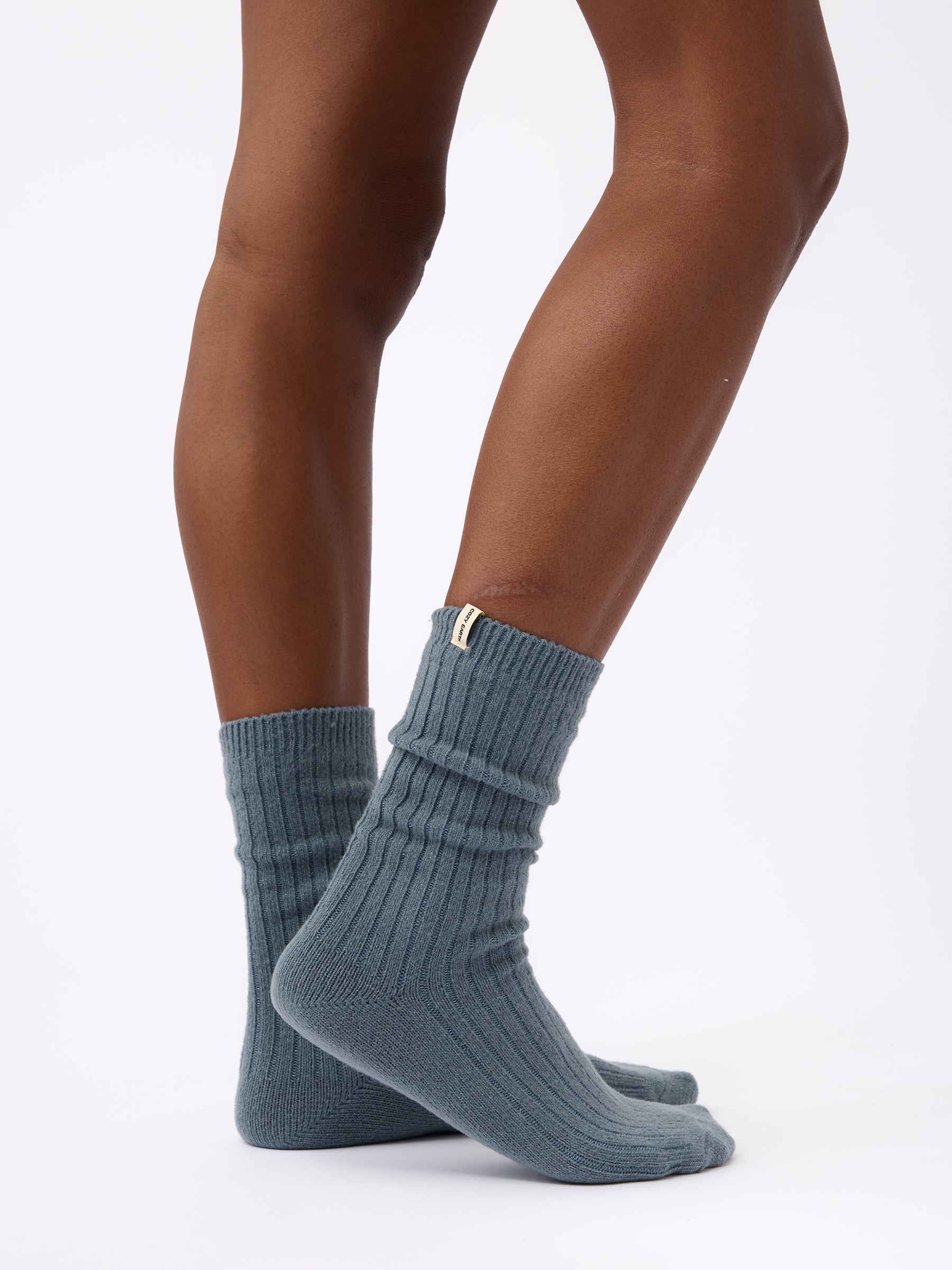Person turned to the side wearing Cozy Earth Plush Lounge Calf Sock 1-Pack  in Deep Blue |Color:Deep Blue