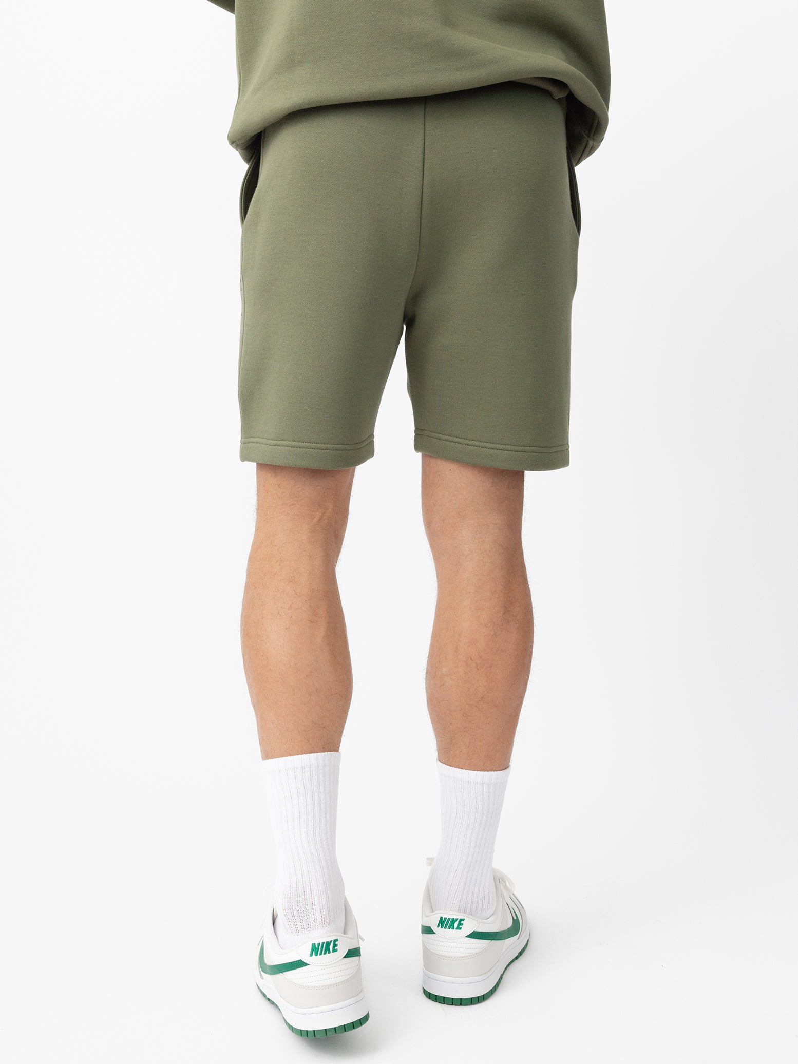 Man wearing Juniper CityScape Shorts with white background |Color: Juniper