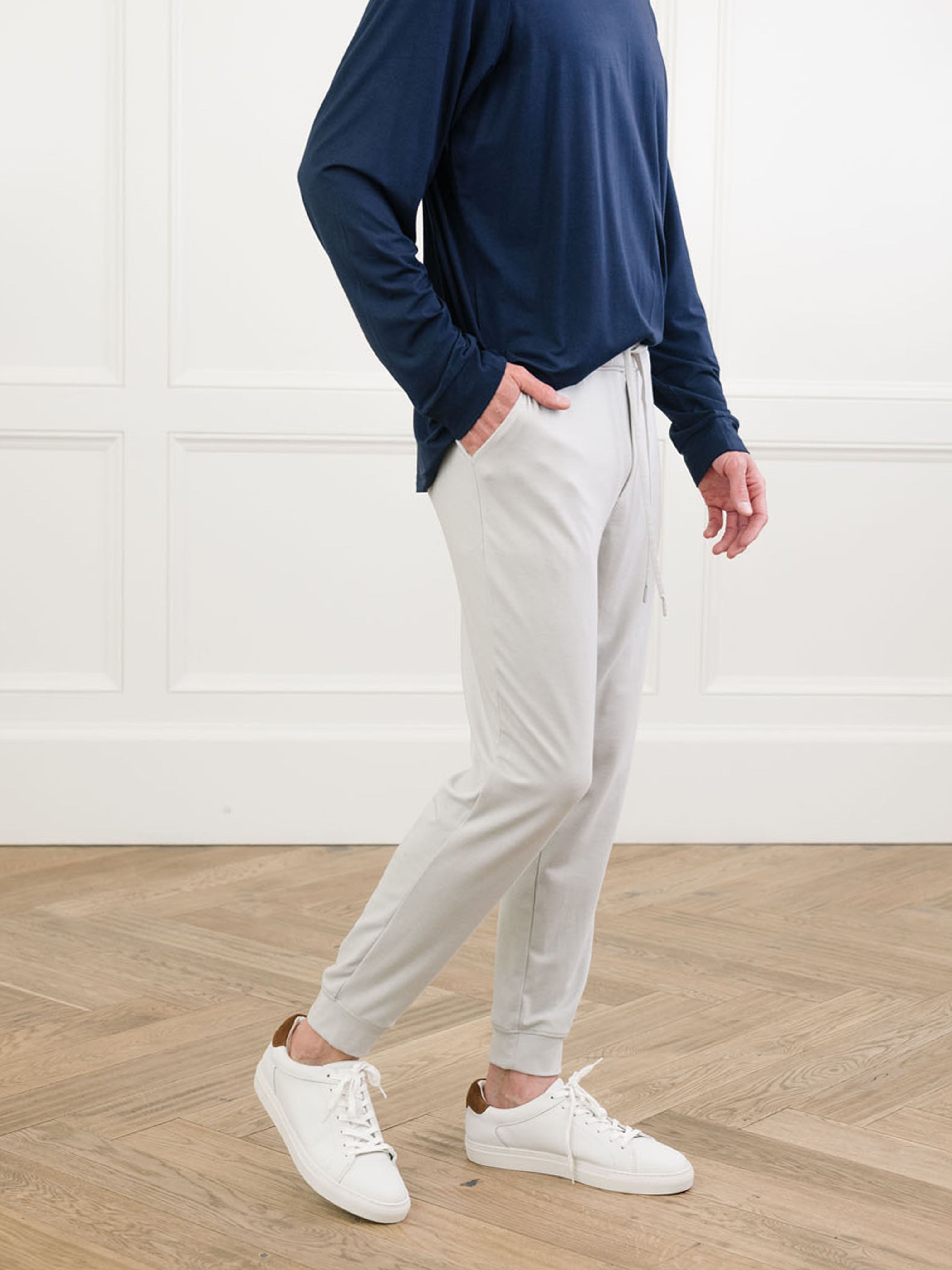 Light Grey/Navy Men's Bamboo Jogger Set. There is a man wearing the jogger set. He is standing in a well lit room in a home.|Color:Light Grey