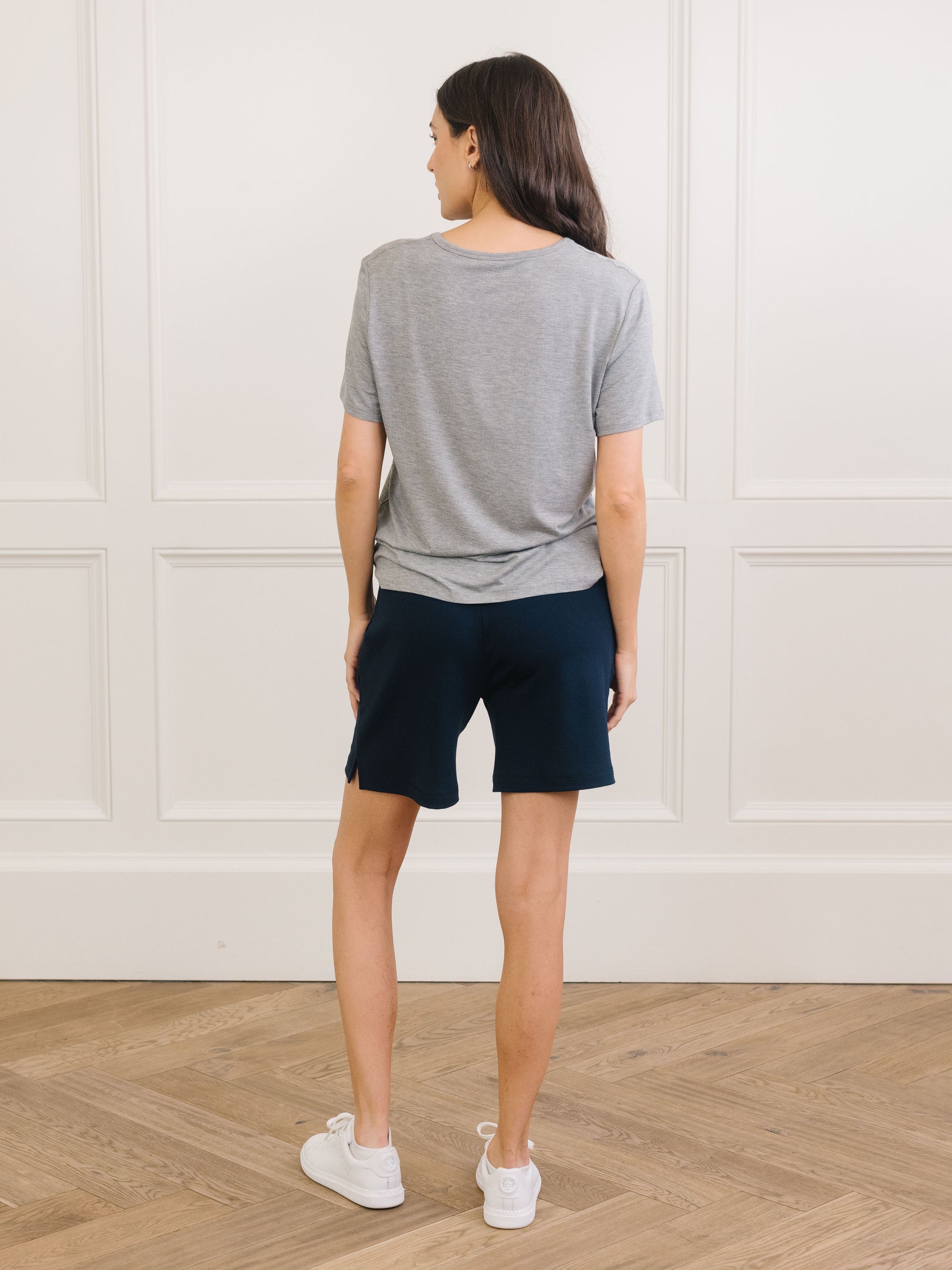 Woman wearing Cozy Earth Bamboo Lounge Tee in grey faces backward 