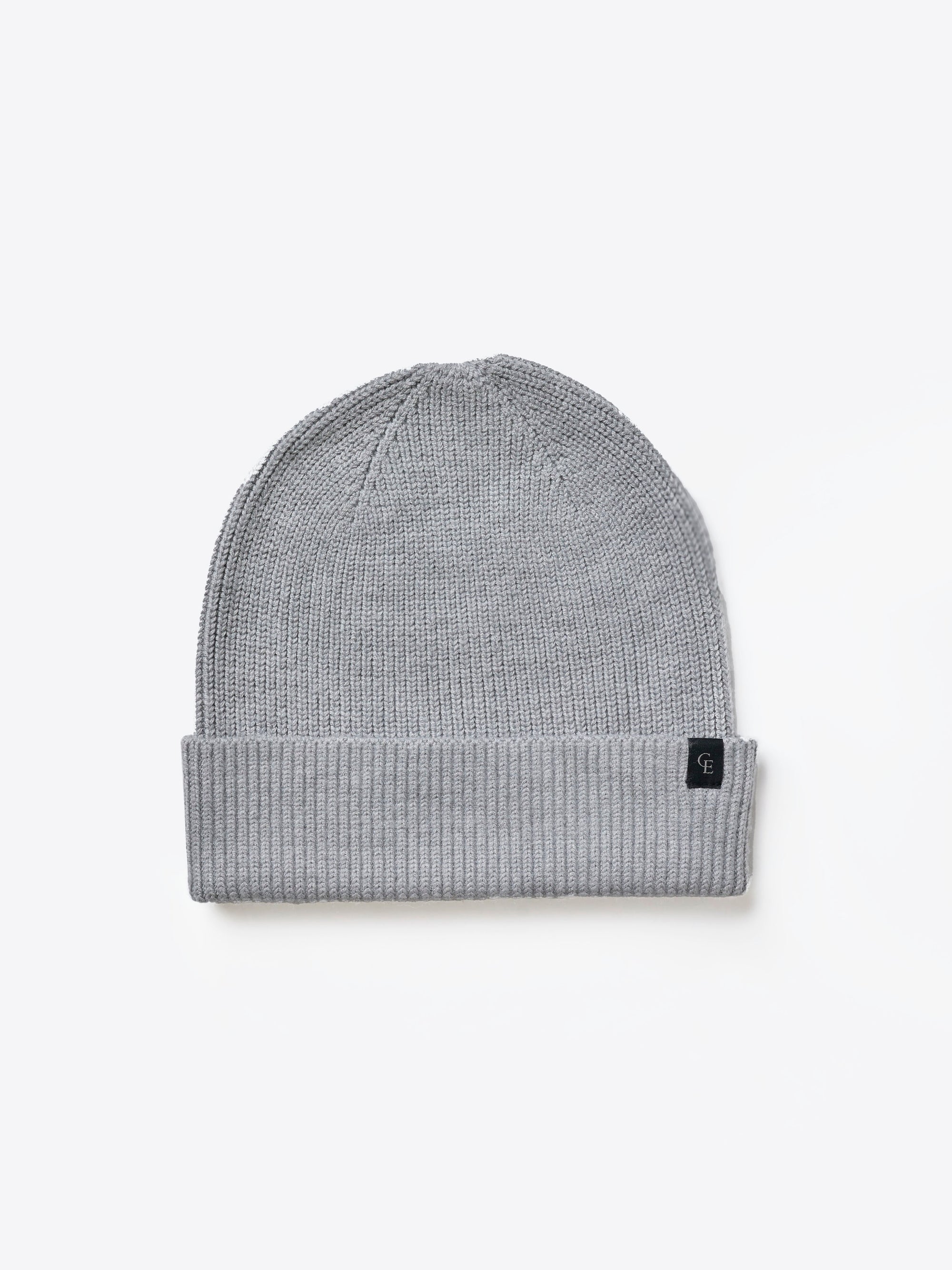 A light gray knit beanie on a white background 