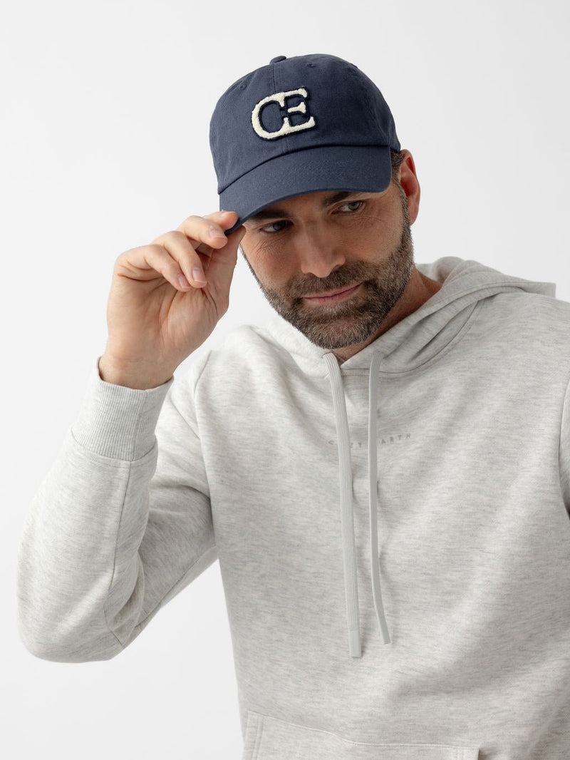Man looking to the side wearing washed navy vintage cap