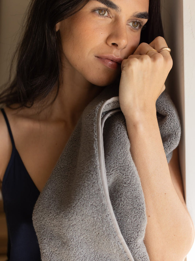 Woman holding charcoal luxe bath sheet