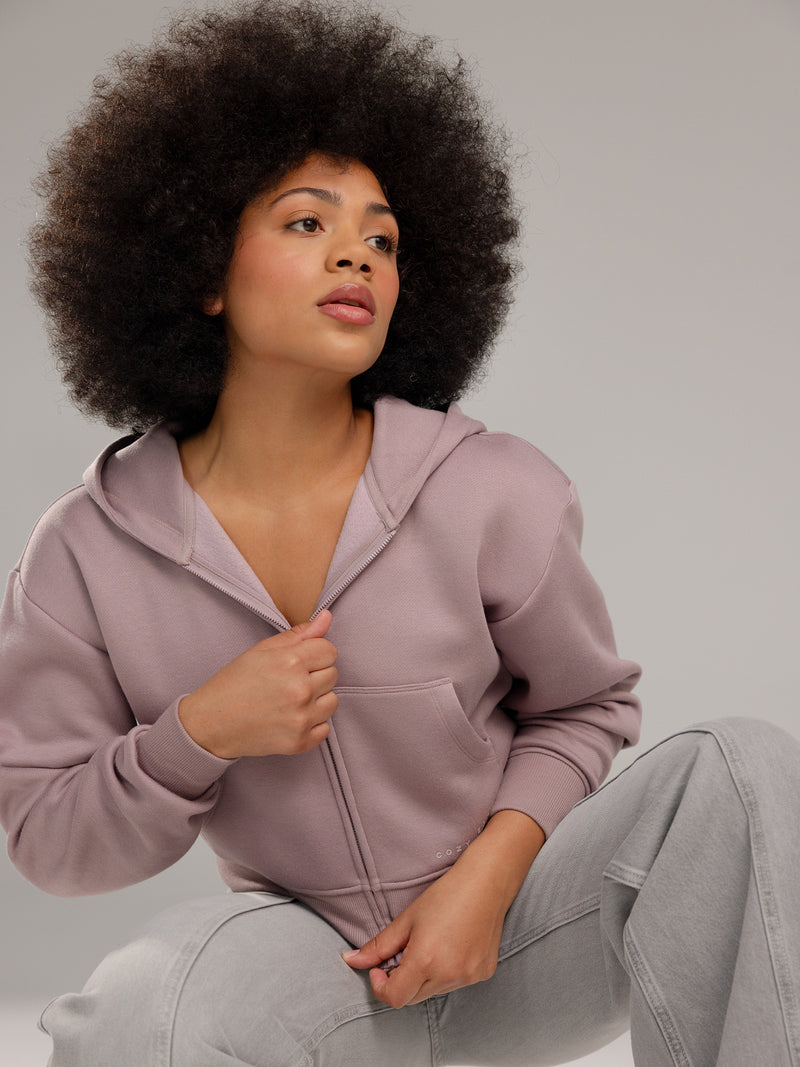 Woman wearing Dusty Orchid CityScape Cropped Full Zip with grey background