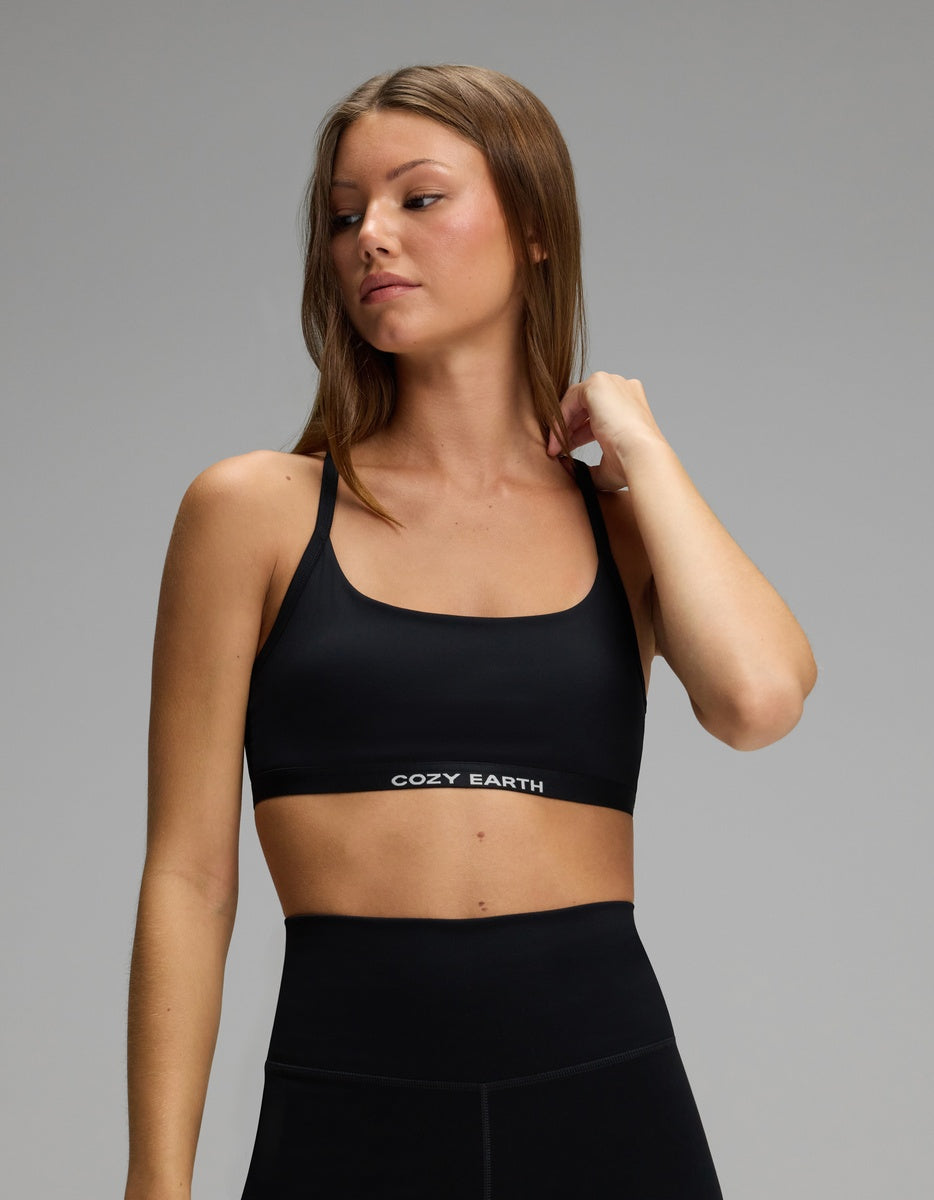 A person wearing a black, scoop-neck Women’s Balance Bra by Cozy Earth with a branded elastic band.|Color:Jet Black