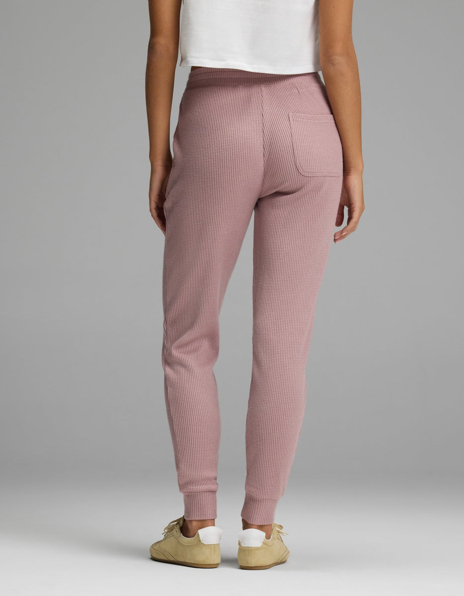 Back view of a person wearing mauve Women’s Blake Waffle Jogger pants featuring a back pocket and cuffed ankles.|Color:Viola