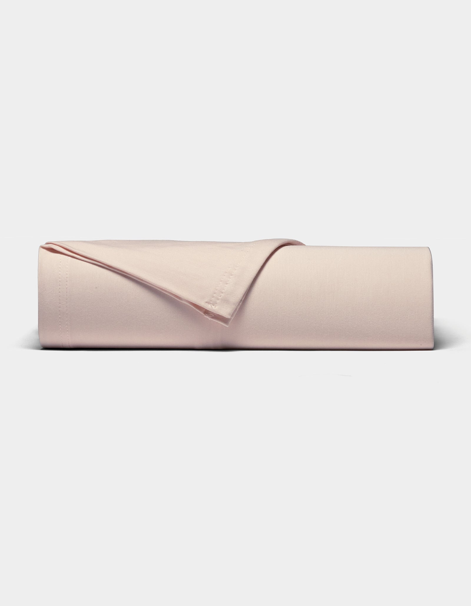 The Cozy Earth Bamboo Jersey Sheet Set, in light pink, is neatly folded and displayed on a plain white background.|Color:Petal