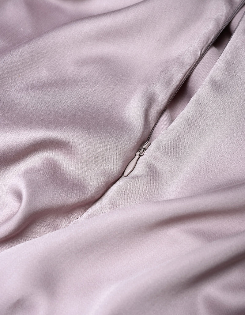 Close-up of the Cozy Earth Bamboo Duvet Cover in light pink, featuring a visible zipper that is partially unzipped to showcase the smooth and shiny satin-like texture of the fabric.