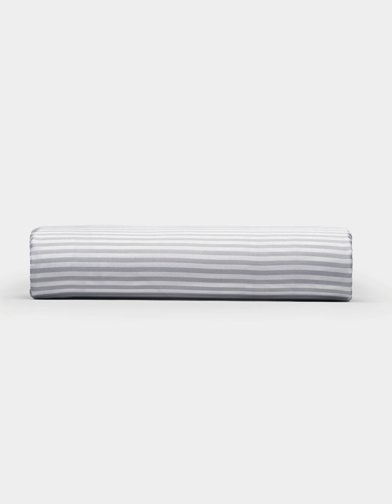 A Bamboo Fitted Sheet by Cozy Earth, featuring a light gray and white horizontal striped pattern, photographed on a plain white background.