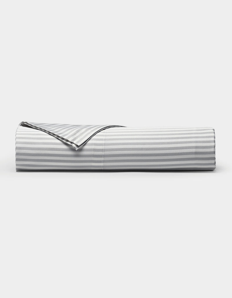 A neatly folded Cozy Earth Bamboo Flat Sheet in a gray and white striped pattern is displayed against a plain white background.