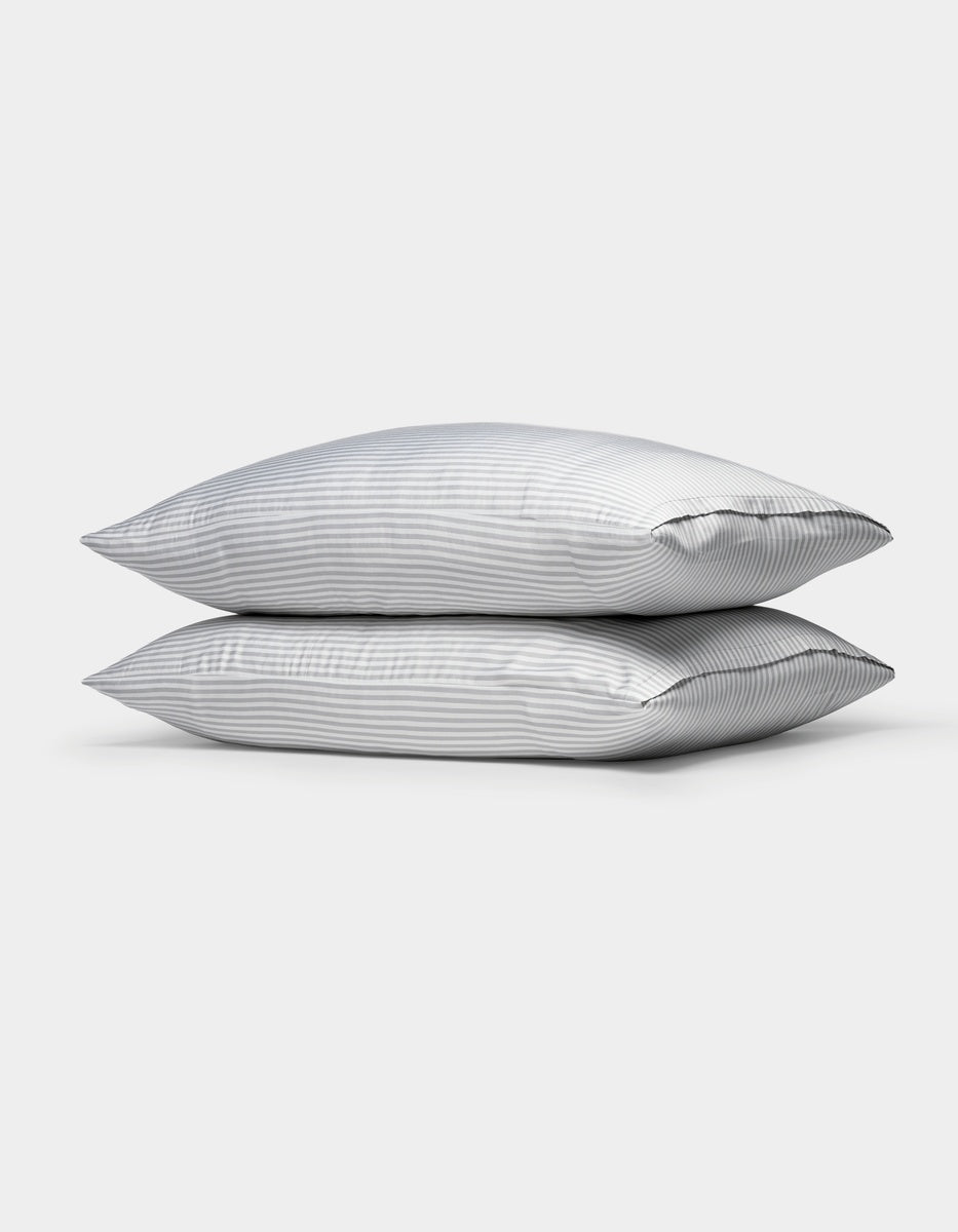 Two Cozy Earth Bamboo Pillowcases stacked on top of each other against a plain white background.|Color:Classic Stripe in Dew