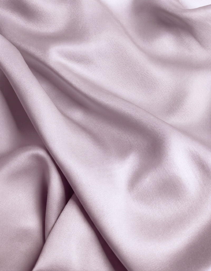 Close-up of the Cozy Earth Bamboo Flat Sheet in a smooth, light lavender shade, featuring gentle folds and a soft sheen that highlights its silky texture.