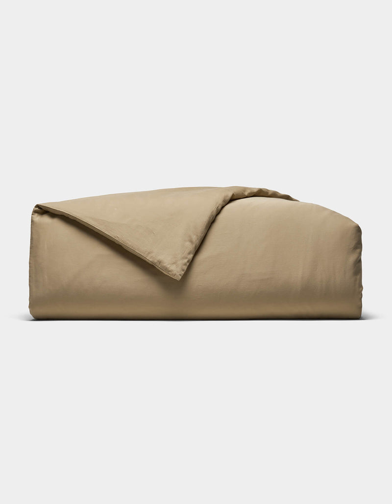 The Cozy Earth Soft-Wash Cotton Duvet Cover is shown folded with a corner turned back, set against a plain white background.