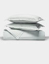 The Cozy Earth Soft-Wash Cotton Quilt Set, featuring two pillows and a folded quilt with light blue and white vertical stripes, is neatly arranged on a white background, highlighting its soft texture.|Color:River and Sea Salt Stripe
