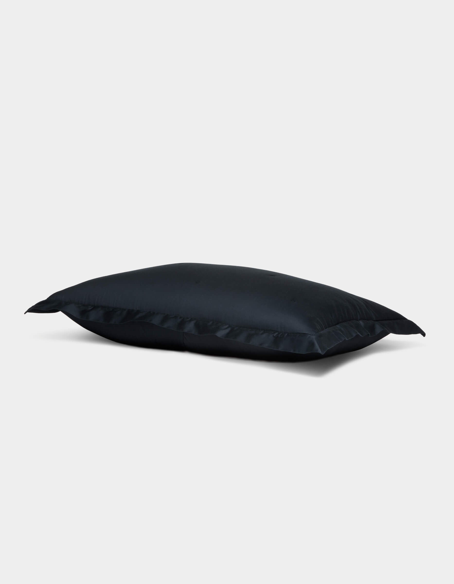 The Soft-Wash Cotton Quilted Sham by Cozy Earth is displayed on a plain light gray background. The rectangular sham appears slightly puffed, featuring neat edges, a smooth surface, and a subtle sheen. |Color:Eclipse