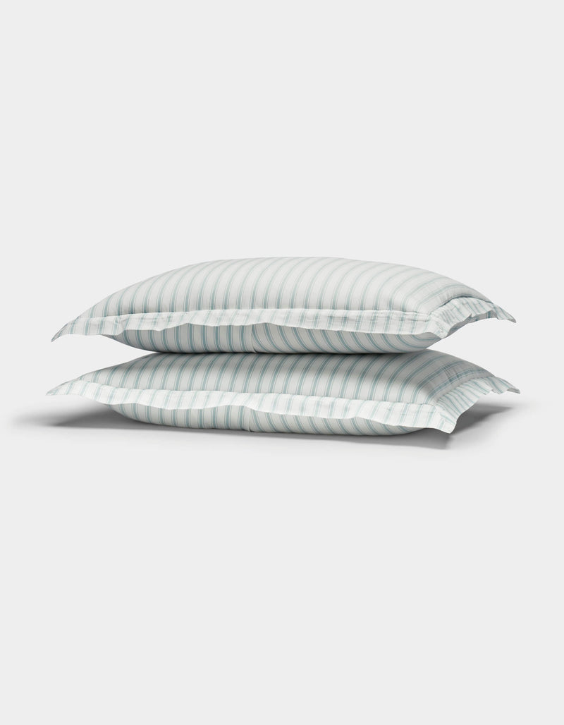 Two Cozy Earth Soft-Wash Cotton Quilted Shams in white with light blue and gray stripes are stacked together against a plain white background.