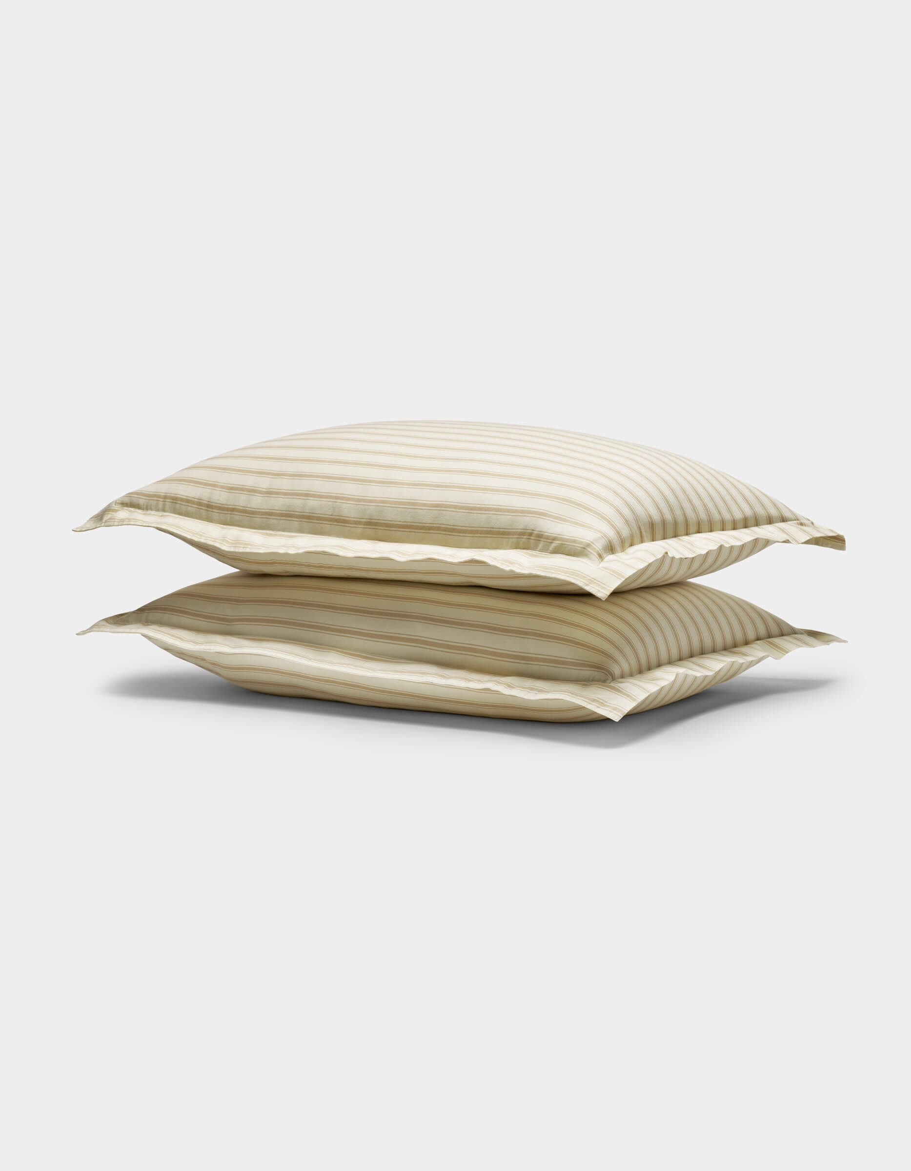 Two stacked Soft-Wash Cotton Shams by Cozy Earth, featuring beige and white stripes with a subtle sheen, displayed against a plain white background.|Color:Coconut and Sandalwood Stripe