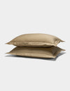 Two Cozy Earth Soft-Wash Cotton Shams in beige are stacked against a plain white background.|Color:Sandalwood