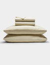 The Cozy Earth Soft-Wash Cotton Sheet Set in beige and light brown stripes is neatly stacked with two pillows at the base, topped with folded sheets and a pillowcase, displayed against a plain white background.|Color:Coconut and Sandalwood Stripe