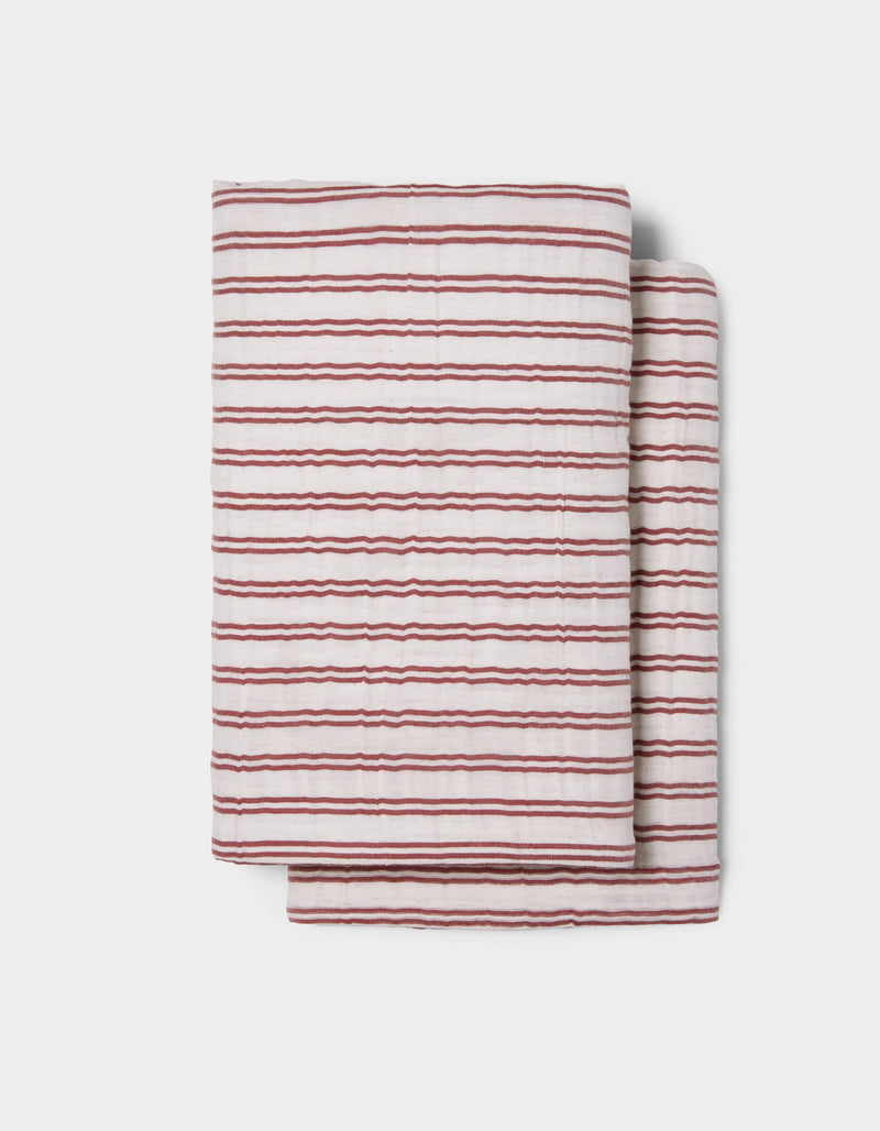 The Cozy Earth Waterfront Shams feature a folded white design with thin, uneven red horizontal stripes, displayed on a plain light background.