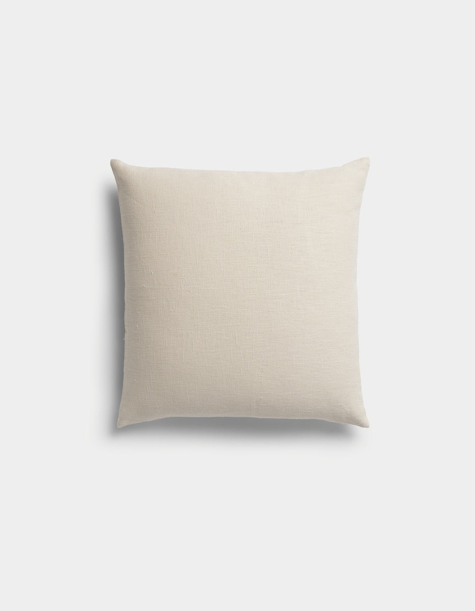 The Sonoma Throw Pillow by Cozy Earth, featuring a plain, light beige square design, is displayed against a white background.