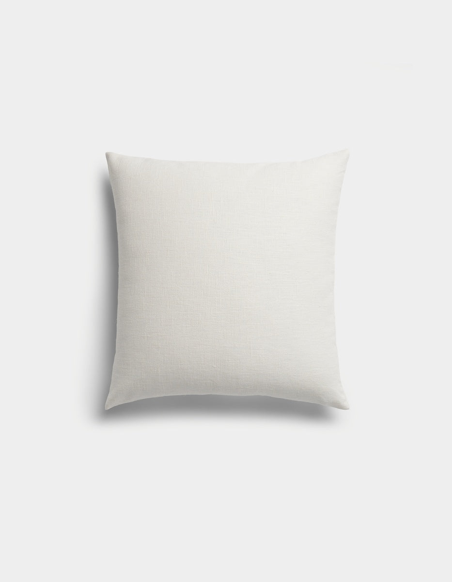 The Sonoma Throw Pillow by Cozy Earth is a plain, square white pillow with a subtle texture, displayed against a light gray background.