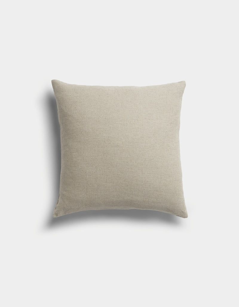 The Sonoma Throw Pillow by Cozy Earth is a square, beige pillow with a soft fabric texture, displayed against a light gray background with a faint shadow on the left side.