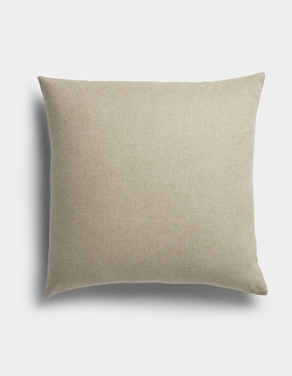 The Sonoma Throw Pillow by Cozy Earth is a square, beige cushion featuring a plain fabric texture, displayed against a white background with a soft shadow to the left.