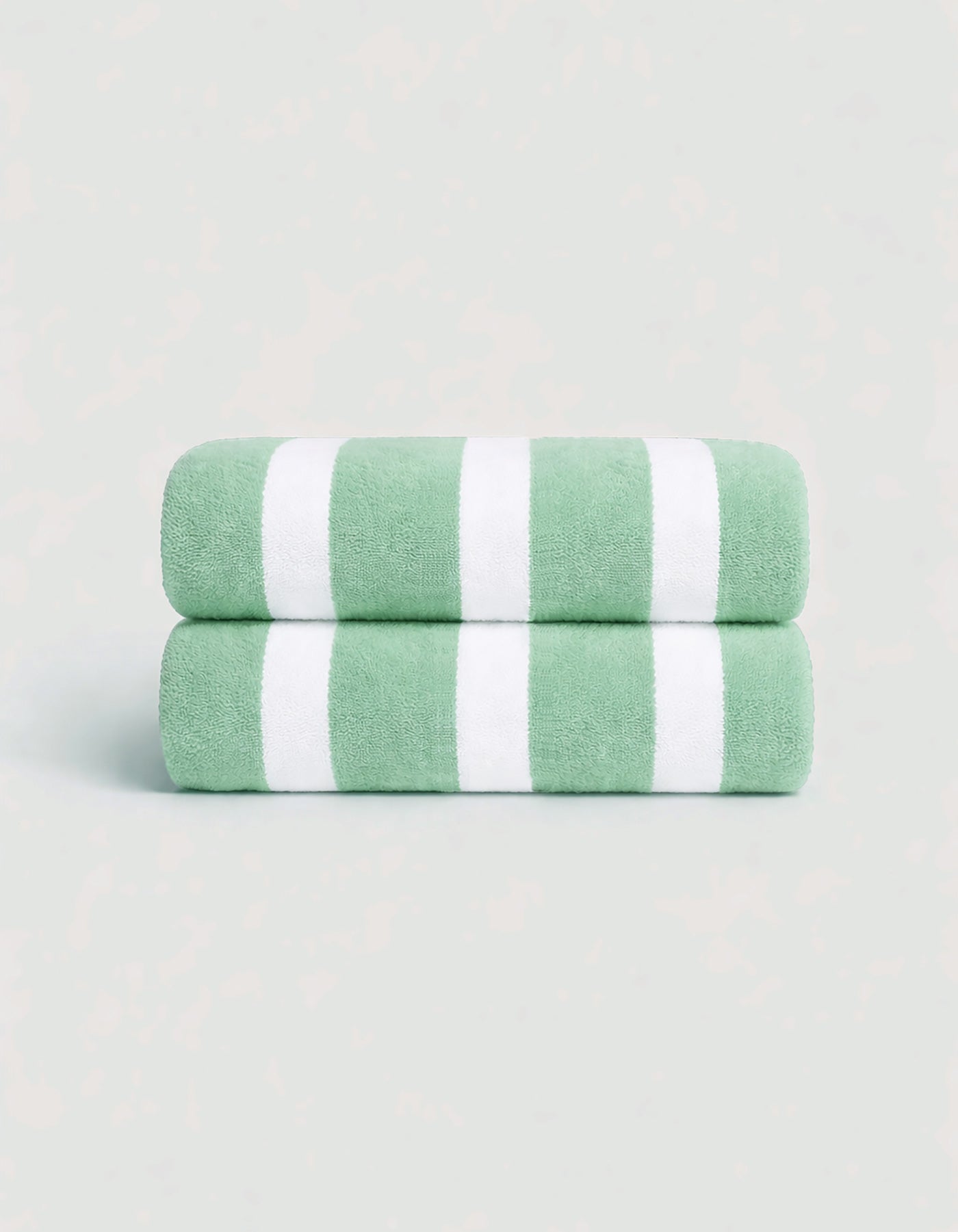 The Cozy Earth Classic Stripe Resort Towel Bundle features two neatly folded towels with wide green and white stripes, stacked together against a light background.