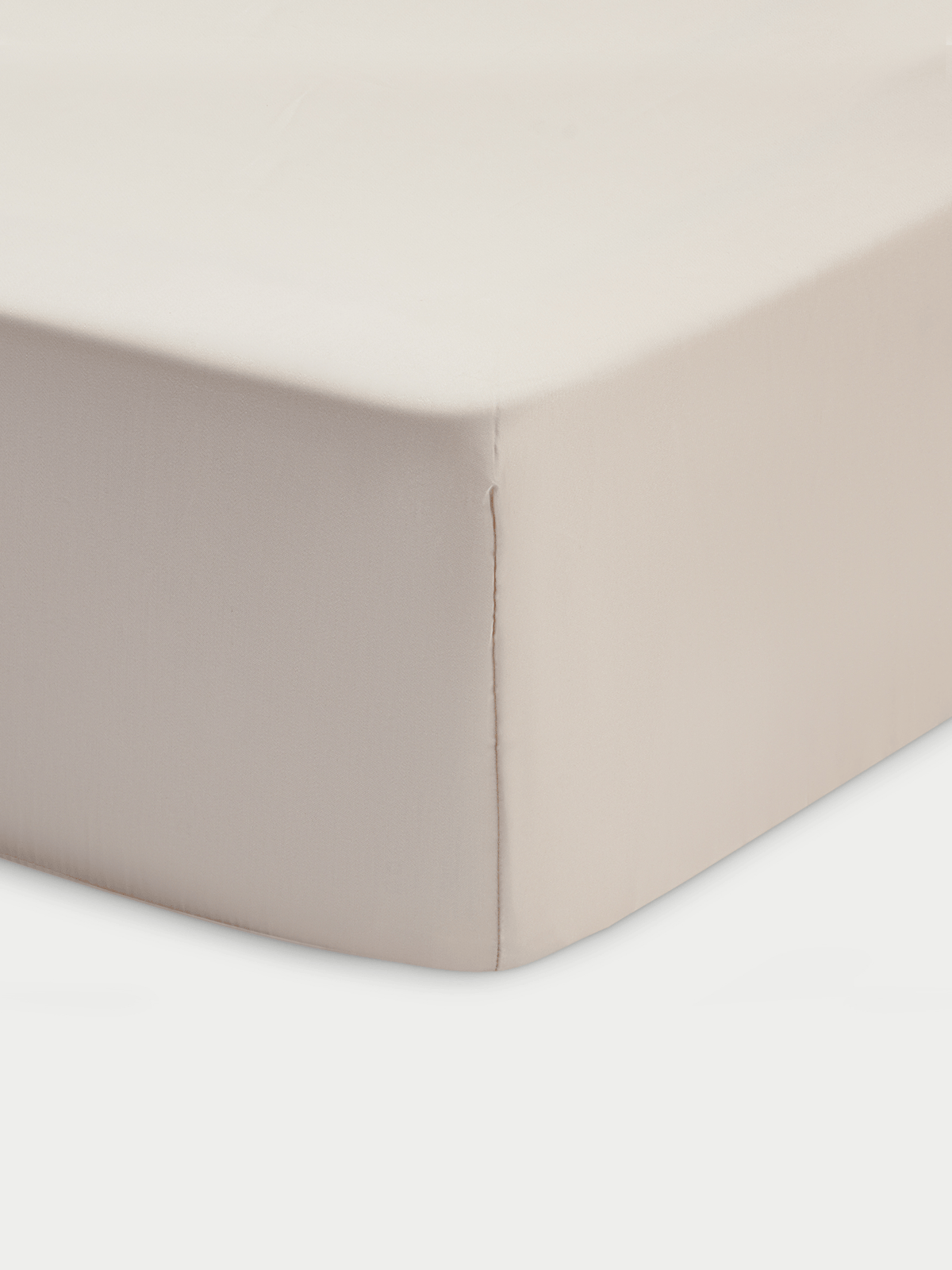 A close-up of the Cozy Earth Bamboo Fitted Sheet in beige, showing smooth fabric and a stitched seam running vertically down the tightly covered mattress corner.|Color:Driftwood
