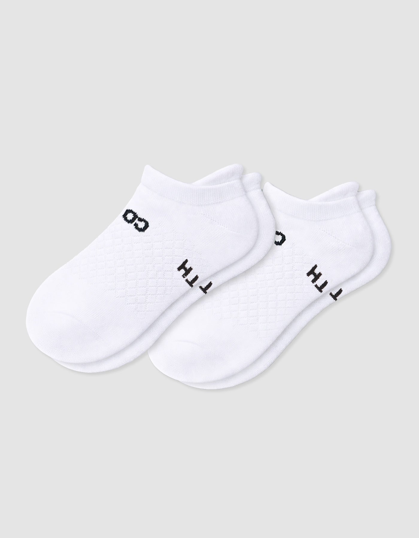 The Women's Essential Ankle Sock by Cozy Earth features a textured white design with subtle black text near the cuff, shown on a light gray background.|Color:White