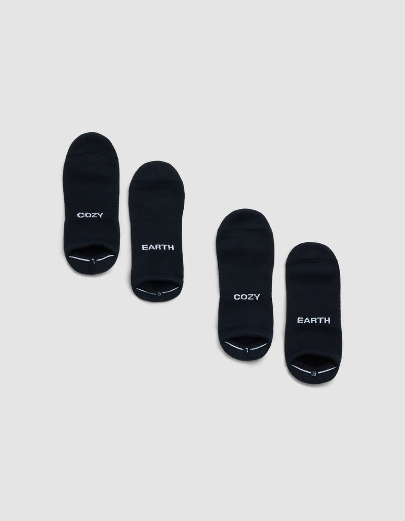 Two pairs of Cozy Earth Essential Ankle Socks in black are shown on a light gray background; each pair features "COZY" and "EARTH" in white lettering, both with matching style.