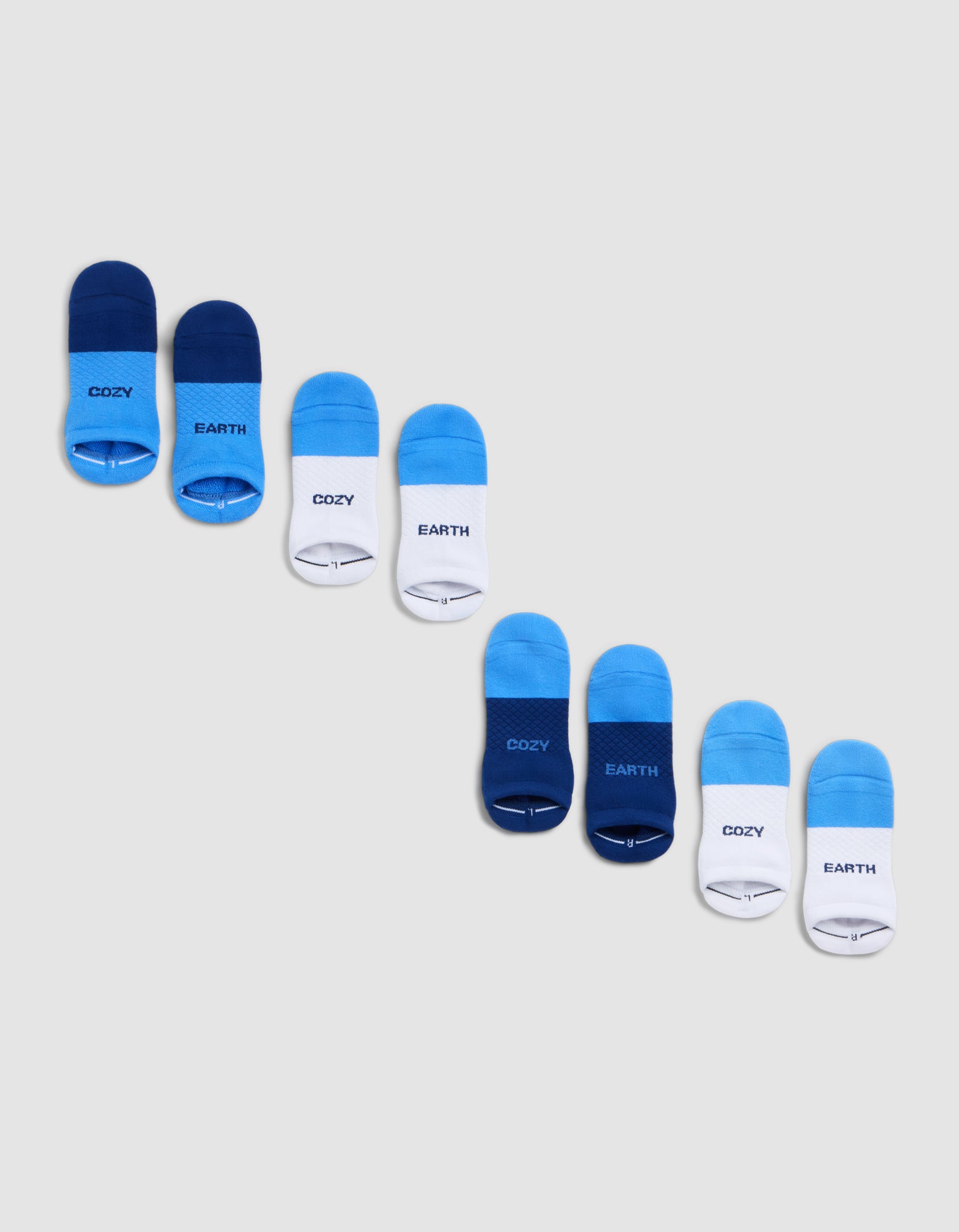 The Cozy Earth Essential Ankle Sock 4-Pack includes eight pairs, arranged diagonally in dark blue, bright blue, and white. Some have "COZY" or "EARTH" printed near the toes. |Color:Harbor