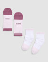 The Cozy Earth Essential Quarter Sock set includes four ankle socks: one pair with white tops and mauve toes and heels reading "COZY" and "EARTH," and one solid white pair with pale pink accents and subtle sole text. |Color:Lilac