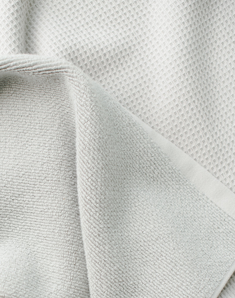 Waffle Bath Towel in the color Light Grey. Photo of Light Grey Waffle Bath Towel taken close up only showing the towel
