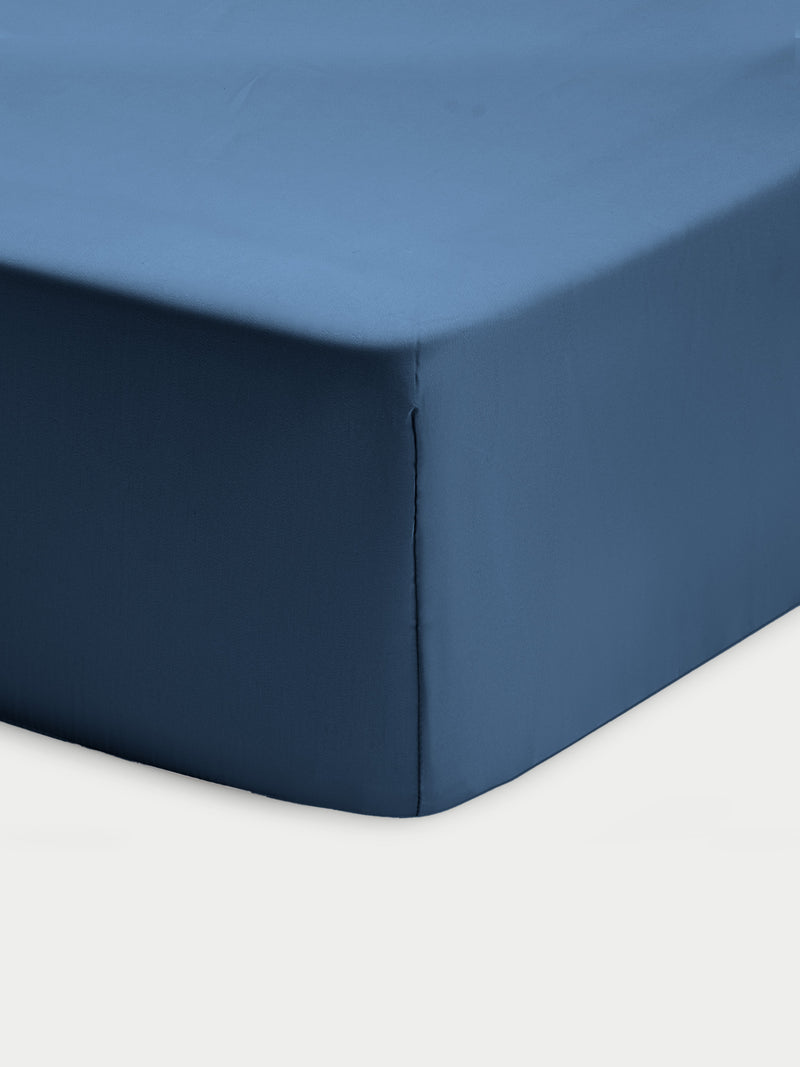 Corner of pacific blue crib sheet with white background
