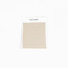 A square fabric sample from Cozy Earth, identified as the Bamboo Sheet Swatch. The swatch is a simple beige color with a zigzag edge design and is attached to a white card. |Color:Driftwood