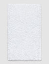 The Cozy Earth Plush Loop Bath Mat is rectangular, white, and features a soft, fluffy chenille shag texture. Shown on a plain light background, it offers plush comfort with its textured surface.|Color:White