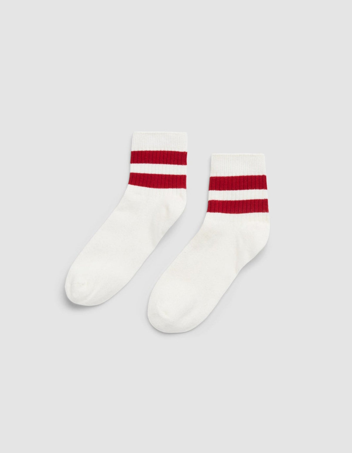 The Women's Sadie Sock by Cozy Earth is a white crew sock with two thick red stripes near the top, shown on a plain light gray background. |Color:Bone/Crimson