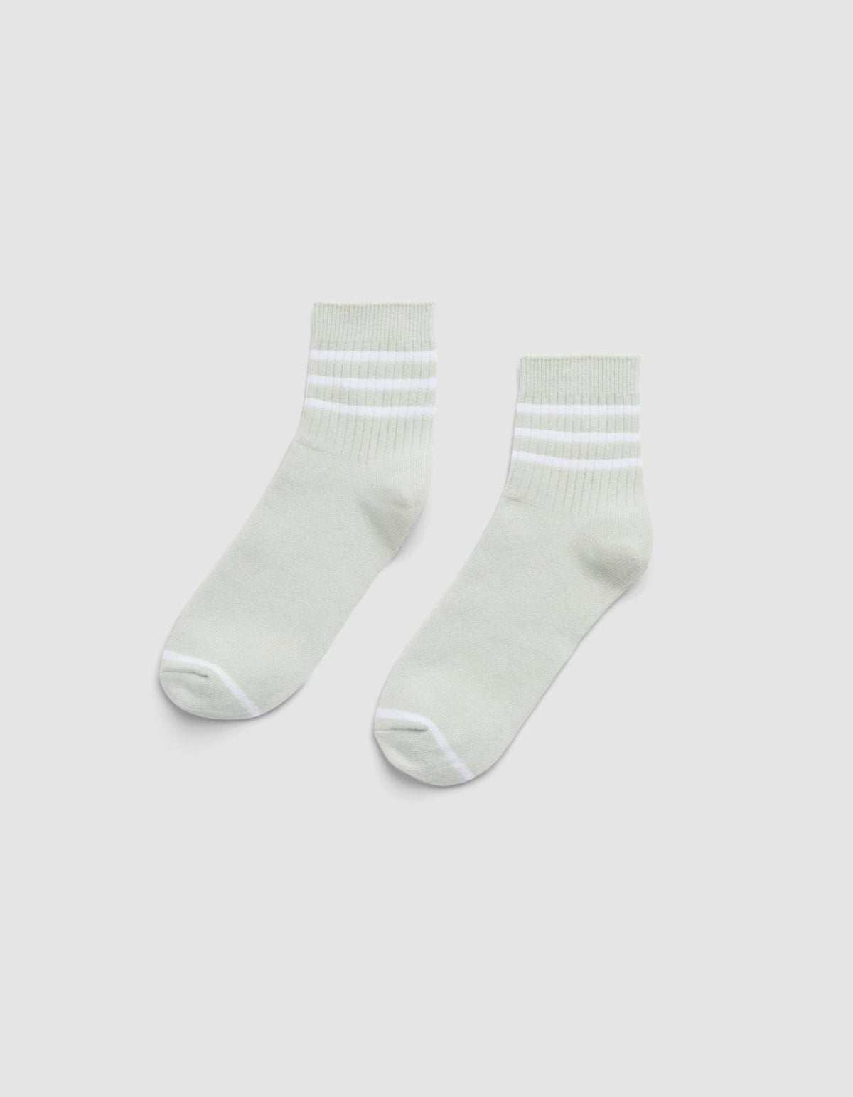 The Cozy Earth Women's Sadie Sock is a pair of light gray ankle socks with white toes, heels, and two white stripes near the cuffs, shown laid flat on a plain white background. |Color:Laurel/White
