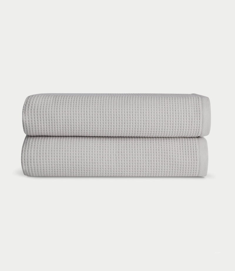 Waffle Bath towels in the color light grey. Photo of light grey Waffle Bath towels taken with white background.
