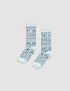 The Cozy Earth Snowflake Plush Lounge Sock features light blue fabric with dark blue geometric and snowflake stripes, shown on a plain light gray background.|Color:Mist