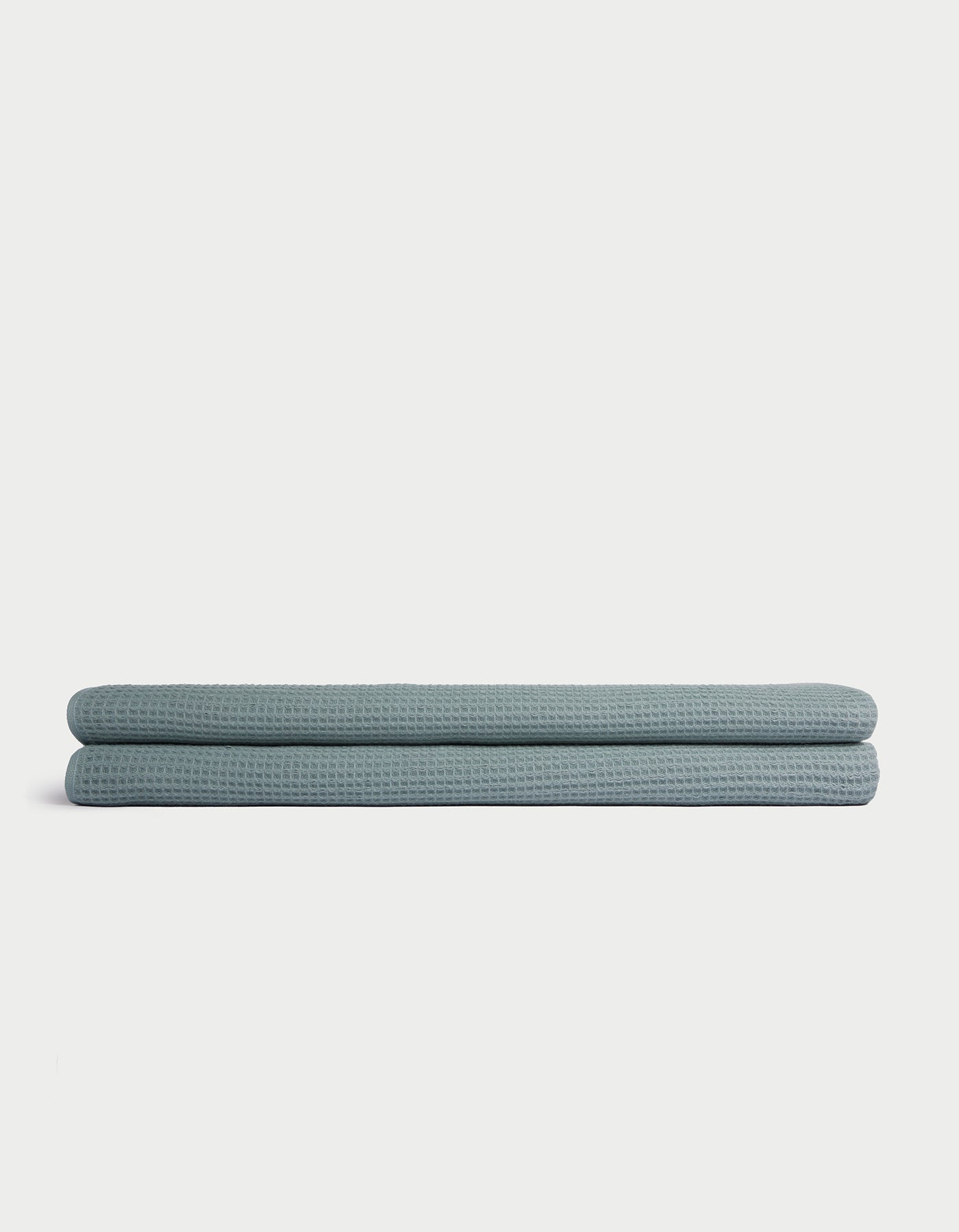 A folded light blue Cozy Earth Waffle Bath Sheet is displayed on a plain white background. |Color:Brook