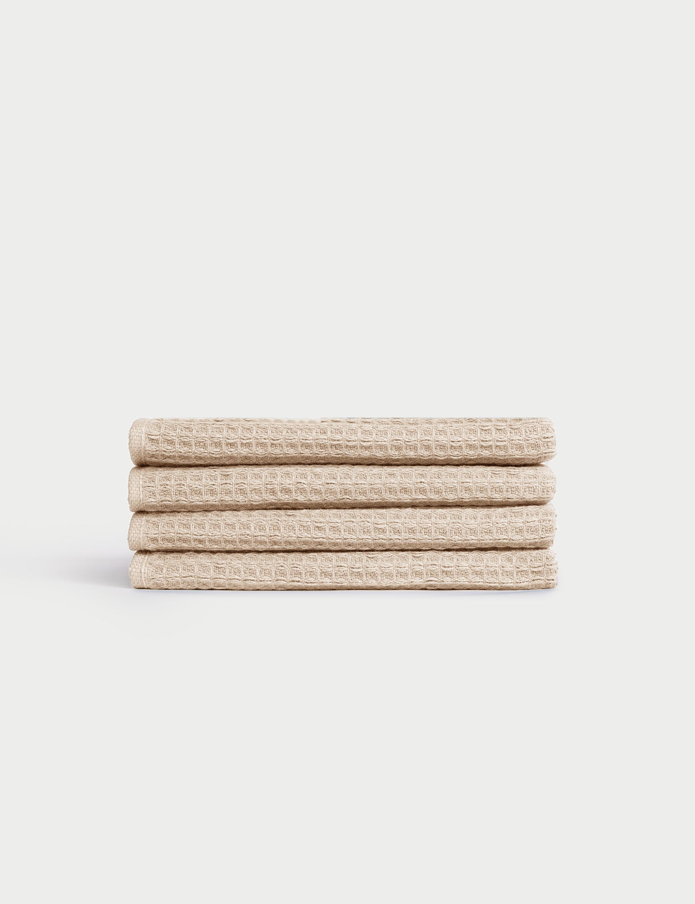 Four neatly folded Cozy Earth Waffle Washcloths are stacked on top of each other against a white background. |Color:Birch