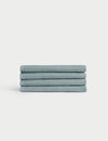 A neatly stacked set of four light blue Cozy Earth Waffle Washcloths with a textured finish on a plain white background. |Color:Brook
