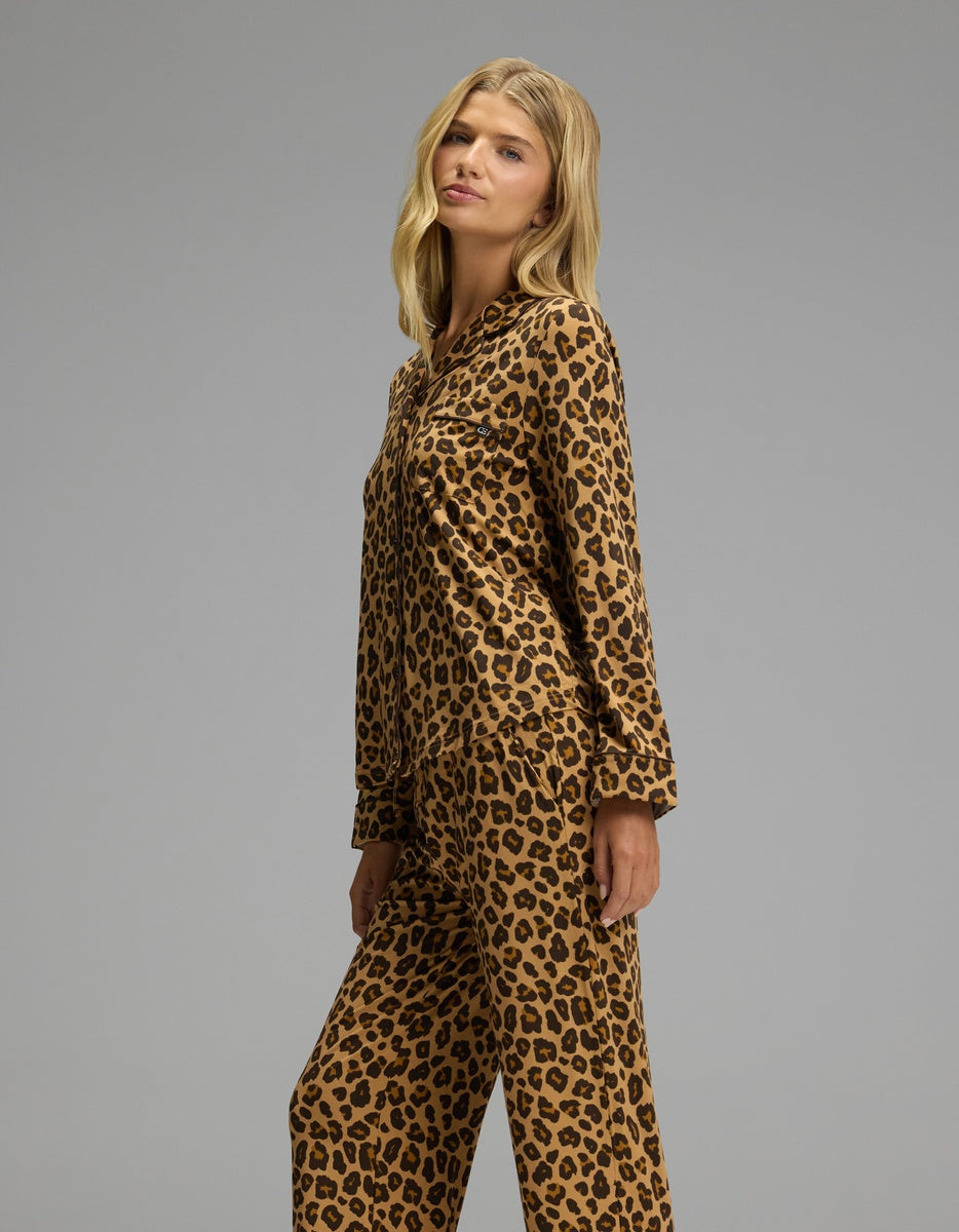 A woman wearing a tan and brown leopard print Women’s Bamboo Stretch-Knit Long Sleeve Pajama Set.