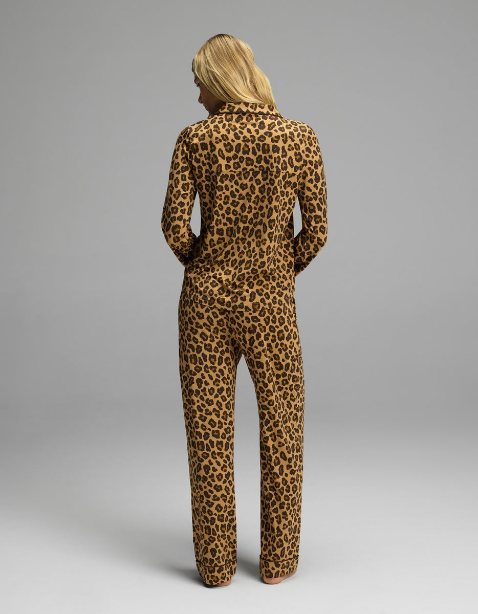 A woman seen from behind wearing a brown leopard print Cozy Earth Women’s Bamboo Stretch-Knit Long Sleeve Pajama Set.